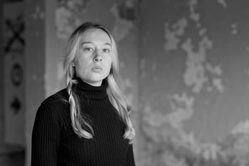 sad girl on a background of an old wall