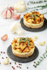 Delicatessen snack for vegetarians (vegans) of fried mushrooms with onions, garlic, thyme and cashew nuts on bread slices. Selective focus