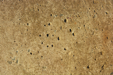 Old polished cement with flaws and bumps, reinforced concrete slab in the sunlight. Construction work, building facade background from natural Ukrainian cement.