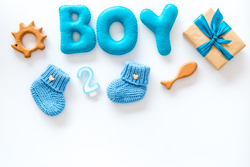 Boy's birthday concept. Set in blue colors with gift box on white backgound top view frame space for text