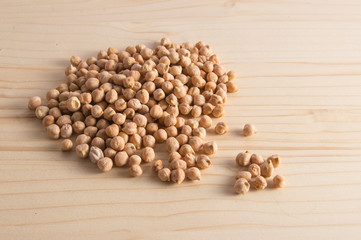 a handful of dry chickpeas isolated on wooden background