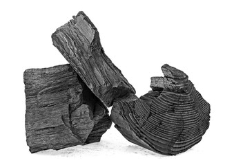 Pile of natural wood charcoal isolated on white background