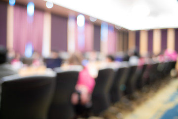 Blurred people sitting in seminar hall room