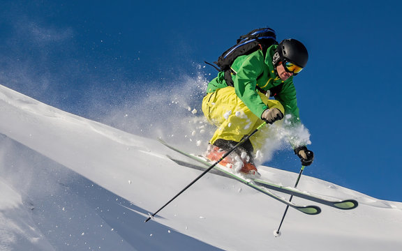 Freestyle Skier jumping off a rock in the Austrian Alps, Arlberg, Salzburg, Austria