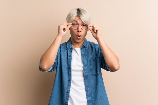 Young Asian Man Over Isolated Background With Glasses