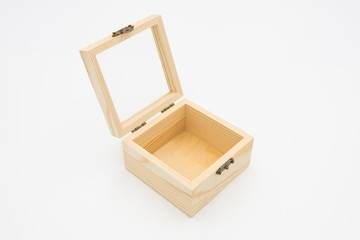 Square wood jewelry box with a glass liopen close-up on a white background isolated top view