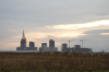 City block construction in autumn evening at sunset