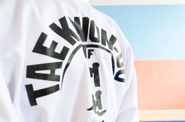 white taekwondo kimono with a confederation sign