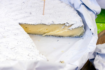 Various varieties of hard cheese on a wooden board. View from above.