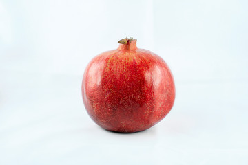 Juicy Ripe Pomegranate Isolated On White Background. Pomegranate isolated on white background. There is a place for text. Healthy food concept.
