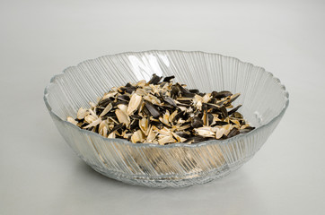A transparent plate with husks from sunflower seeds