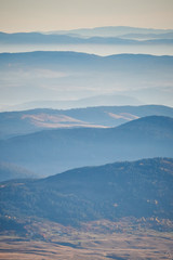 Naklejka premium Morning fog/mist under the mountains. Montenegro mountains. Vertical photo.