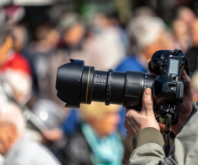 Reporter shots with a professional black photo camera