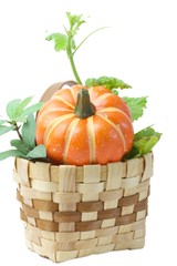 Pumpkin in a basket isolated on white background