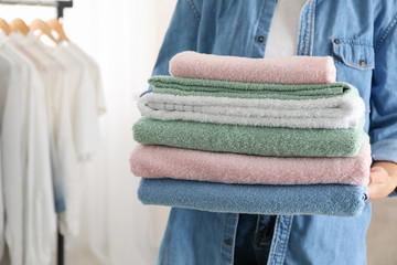 Young woman hold clean towels, close up and space for text © Atlas