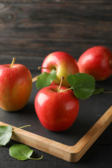 Apples and cutting board on wooden background, space for text
