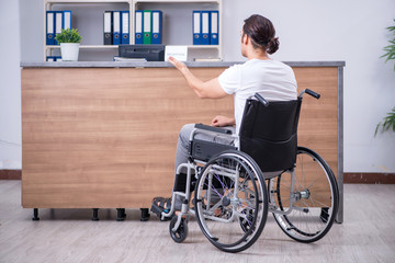 Young man at hospital reception desk