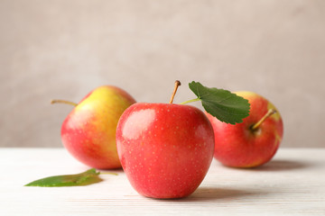 Apples on white wooden background, space for text