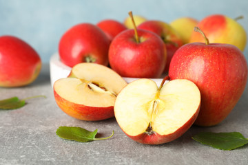 Red apples on grey background, close up