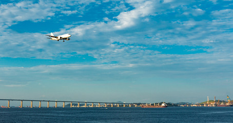 Fototapeta na wymiar Plane approaching rio de janeiro crossing the Rio-Niterói Bridge