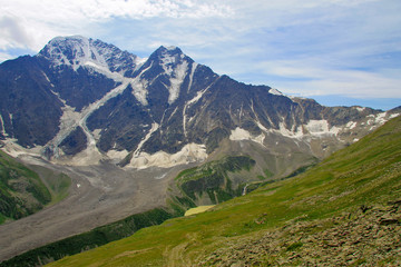 Snowy mountains of Northern Caucasus and small lake