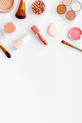 Makeup concept. Frame with decorative cosmetics and brushes on white background top view copy space