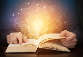 open magic book with shining light sparkles