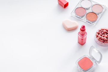 Decorative cosmetics frame with rounge, powder and tools on white background copy space