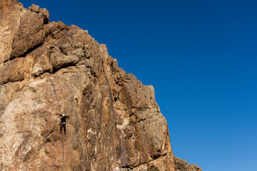 rear view of rock climber on a vertical wall