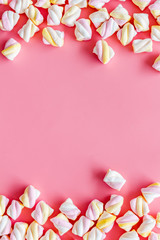 Sweets. Marshmallows frame on pink background top view copy space