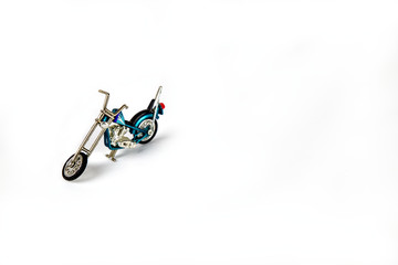 Photo of a toy motorcycle on a white seamless background.