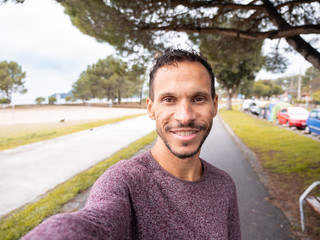 man smiling while doing a selfie