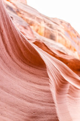 Pink red wave shape sandstone abstract formations vertical view of rocks with sky at Antelope slot canyon in Arizona on trail from Lake Powell