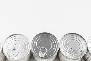 Group of silver canned food on white background.