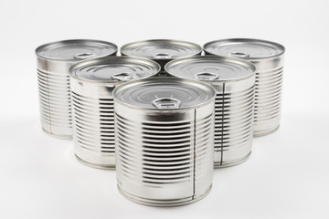 Group of silver canned food on white background.