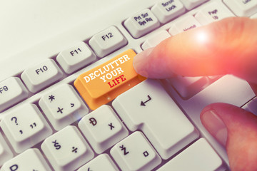 Handwriting text writing De Clutter Your Life. Conceptual photo remove unnecessary items from untidy or overcrowded places White pc keyboard with empty note paper above white background key copy space