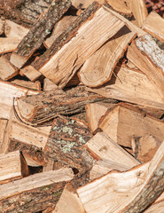 Preparation for the heating season. Chopped wood close-up. Brown colors. Background, texture. Vertical