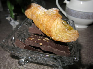 tea with croissant, creamer and candy maker