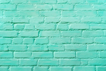 Wide horizontal teal turquoise or aqua mint green brick wall background. 