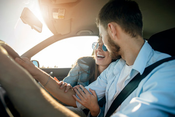 Pretty girl is extremely contented with the car trip arranged by her boyfriend