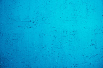 Old blue cracked paint on wooden background.