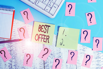 Conceptual hand writing showing Best Offer. Concept meaning To convince someone by rendering all the greatness you can give Writing tools and scribbled paper on top of the wooden table