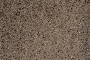 Lumpy surface texture, small pebbles.