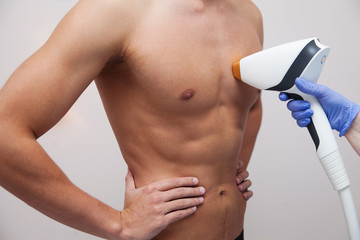 Muscular athlete man with smooth clear skin. Epilation and depilation of hair in beauty salon. Male...