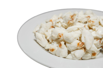 Top view of pile of fresh steamed crab meat without shell and ready to eat on white dish isolated on white background.