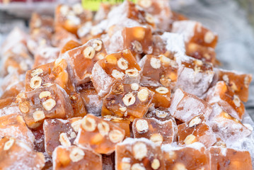 Turkish delight with hazelnut. Arabic sweets in the market.