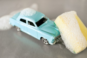 Car wash scene with small mass production toy model of soviet popular vintage car Volga GAZ-21,...