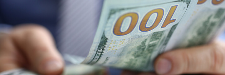 The businessman considers cash dollars in the office