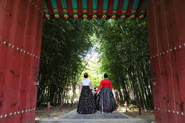Fototapeta premium Korean women dressed in hanbok and touring the Gyeonggijeon at Korean traditional house Village in Jeonju, Jeollabuk-do, South Korea.