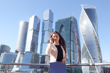 Fototapeta na wymiar Businesswoman at skyscraper background